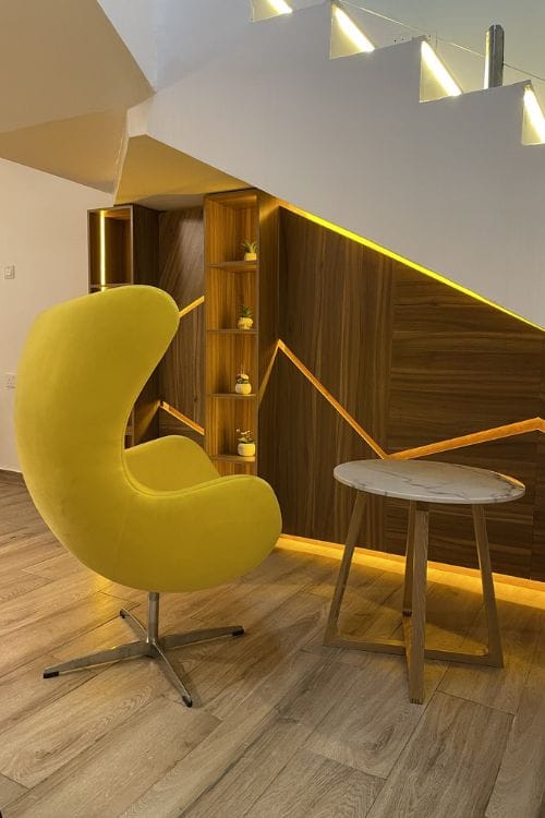 Compact home mini bar cabinet with built-in shelves and warm ambient lighting, designed by DecorEffect Nigeria.