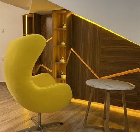 Compact home mini bar cabinet with built-in shelves and warm ambient lighting, designed by DecorEffect Nigeria.