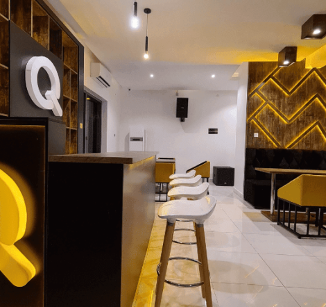 Luxury lounge interior design with deep-toned textures and soft ambient lighting by DecorEffect Nigeria.